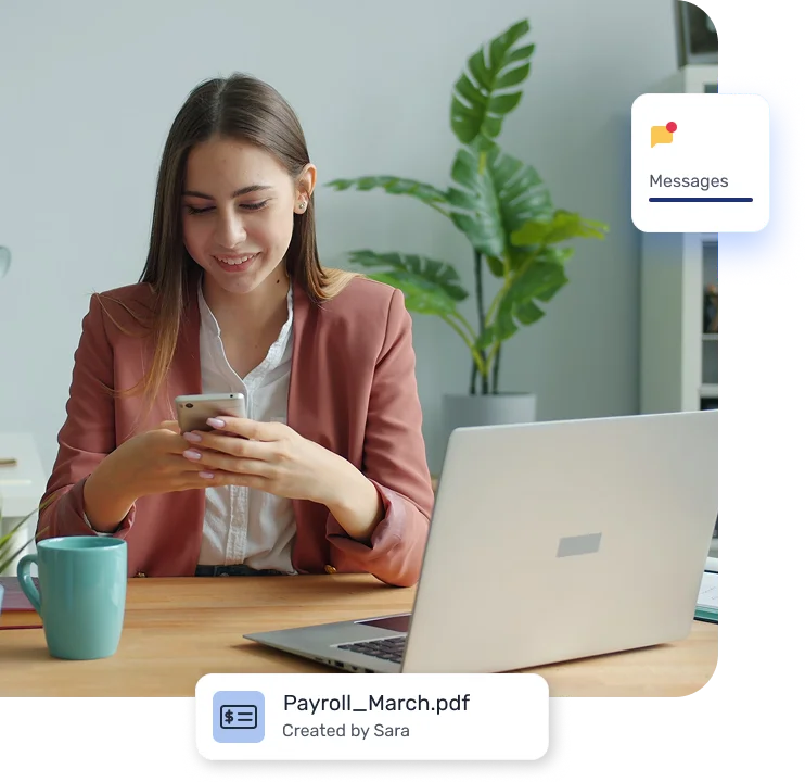 Woman at a desk using a smartphone with a laptop nearby and a coffee mug present; desktop notifications show 'Messages' and a file 'Payroll_March.pdf' created by Sara.
